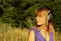 Girl walking and listening to music outdoors