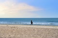 Girl is walking near the sea. Young woman walks along the sand of a beach near Mediterranean Sea Royalty Free Stock Photo