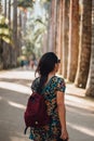 Girl walking on a palm tree road. Royalty Free Stock Photo