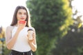 Girl walking in the Park speaking on Smartphone. Happy girl using a smart phone voice recognition audio ai message Royalty Free Stock Photo