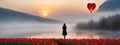 The girl walking in red tulip field, a heart shaped balloon ahead.concepts of lonely Valentine\'s Day Royalty Free Stock Photo