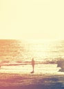 Girl walking into sea on sunset time Royalty Free Stock Photo