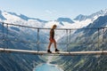 Girl Walking on a Suspension Bridge Watching an Alpine Mountain Landscape Royalty Free Stock Photo