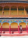 A cute girl walking in Tibetan Buddhist Temple. Leh, Kashmir, In