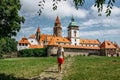 Girl walking to Bouzov Castle,Czech Republic.Romantic fairytale chateau with eight-storey watchtower built in 14th century. Royalty Free Stock Photo