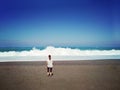 Girl walking to the stormy sea Royalty Free Stock Photo