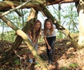 Girl walking under fallen trunk