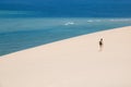 Girl walking on the white dunes on the Bazaruto Island