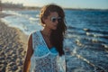 Girl walking on a windy beach Royalty Free Stock Photo