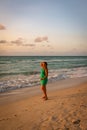 Girl walks along the beach in a dress