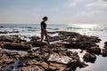 girl walks along a rocky beach. walk along the sea Royalty Free Stock Photo