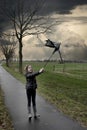 Girl walks with broken umbrella through the storm