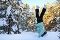 girl walks in early winter morning and does sports outdoors. Teenage girl does handstand in snow. Concept of sports