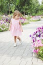 Girl walks on a flowers alley