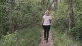 a girl walks through the forest