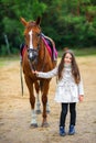 Girl walks with her beloved horse Royalty Free Stock Photo