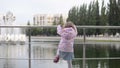 Girl walks in the park, climbs the fence Royalty Free Stock Photo