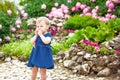 Girl walks in the Park with flower beds