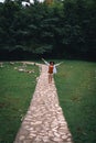 The girl walks in the park, a trail in the woods. Tourism and vacation. Okatse Canyon. Vertical photo