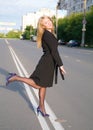 Girl walks on town lonesome road. Royalty Free Stock Photo