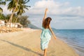 Girl walks on a tropical beach in a dres Royalty Free Stock Photo