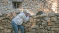 A girl war photographer takes pictures of the devastation after the bombing in the war Royalty Free Stock Photo