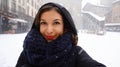 Girl in warm scarf and cap take self portrait in winter snow old