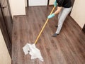 The girl washes the floor with a mop and a rag Royalty Free Stock Photo