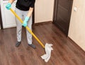 The girl washes the floor with a mop and a rag Royalty Free Stock Photo