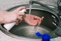 Girl washes hands in the sink using a disinfectant. Prevention of the spread of viruses