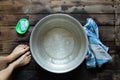 girl washes her feet in a basin of water on the wooden floor at home, foot care, wash feet at home, hygiene, swim Royalty Free Stock Photo