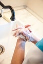 Girl washes her hands with soap to prevent infection with the covid-19 virus