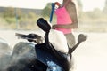 Girl washes a motorcycle in self service car wash with high pressure water jet. Royalty Free Stock Photo