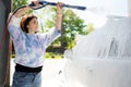 Girl washing a car in a self-service car wash station Royalty Free Stock Photo