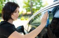 Girl washing her car with sponge on a car wa Royalty Free Stock Photo