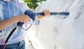 Girl washing a car in a self-service car wash station Royalty Free Stock Photo