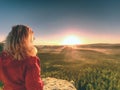 Girl watch Sun rising at horizon. Colorful spring valley Royalty Free Stock Photo