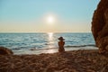 Girl watch sunset over sea. Beautiful landscape on beach. Time to relax, summer time and holiday trip idea, copy space Royalty Free Stock Photo