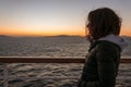 Girl watching a beautiful sunset from the deck of a cruise ship Royalty Free Stock Photo