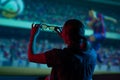 The girl is watching football, soccer in 3D, with glasses on the big screen. with entertainment and relaxation. action, rest in Royalty Free Stock Photo