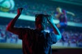 The girl is watching football, soccer in 3D, with glasses on the big screen. with entertainment and relaxation. action, rest in Royalty Free Stock Photo