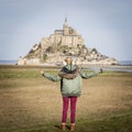 Girl watching the Mont Saint Michel Normandy France. Royalty Free Stock Photo