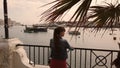 Girl watching the ships at sunset