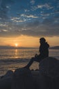 A girl watching a sunrise over the sea in Varna.