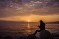 A girl watching a sunrise over the sea in Varna