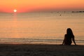 Girl watching sunset on beach Royalty Free Stock Photo