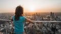 Girl watching sunset from a high building in Bangkok, Thailand, Asia
