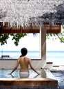 Girl watching towards the sea in swimming pool