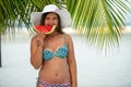 Girl with watermelon under palm tree Royalty Free Stock Photo