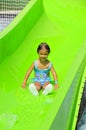 Girl smiling while sliding down a waterslide. Royalty Free Stock Photo